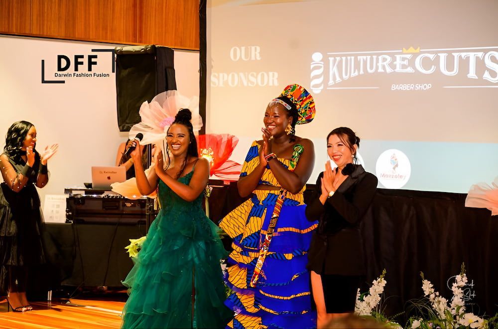 A Group of Women Are Standing in Front of a Screen That Says Our Sponsor — Eternal Weddings & Couture In Woolner, NT