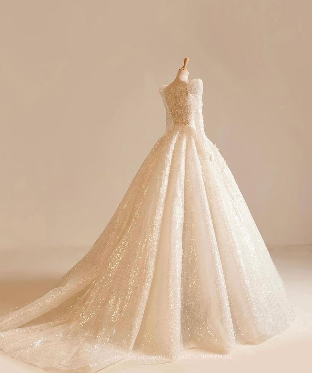 A White Wedding Dress With Long Sleeves Is On A Mannequin — Eternal Weddings & Couture In Woolner, NT