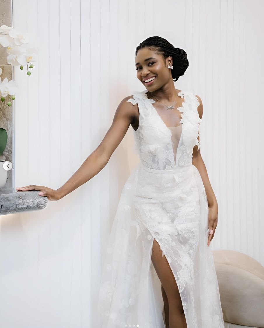 A Woman In A Wedding Dress Is Leaning Against A Wall — Eternal Weddings & Couture In Woolner, NT