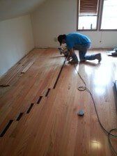 Man Installing Wood Panels — Bergen County, NJ — Alpine Hardwood Flooring