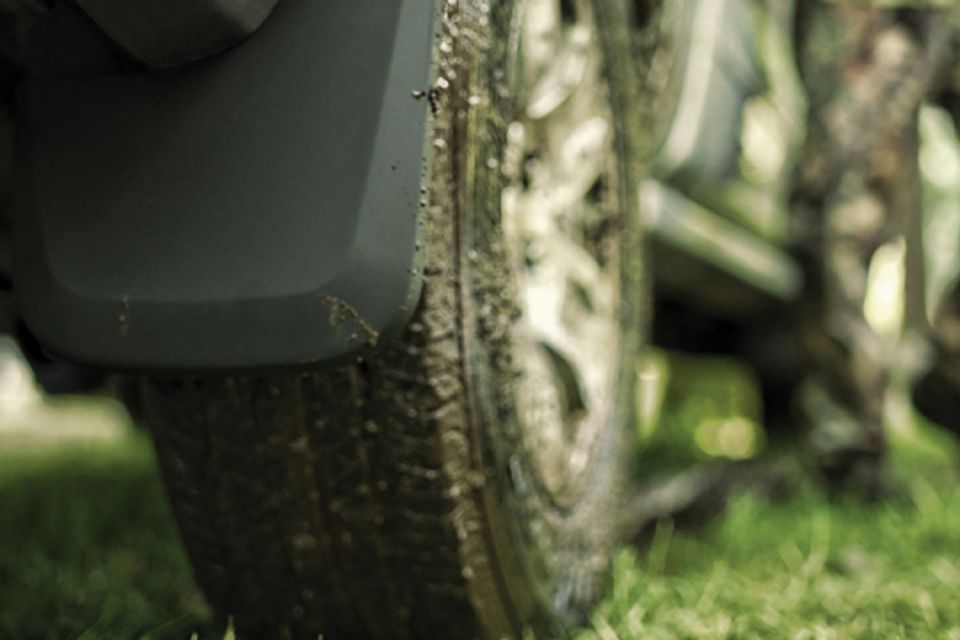 A close up of a motorcycle tire on a grassy field.