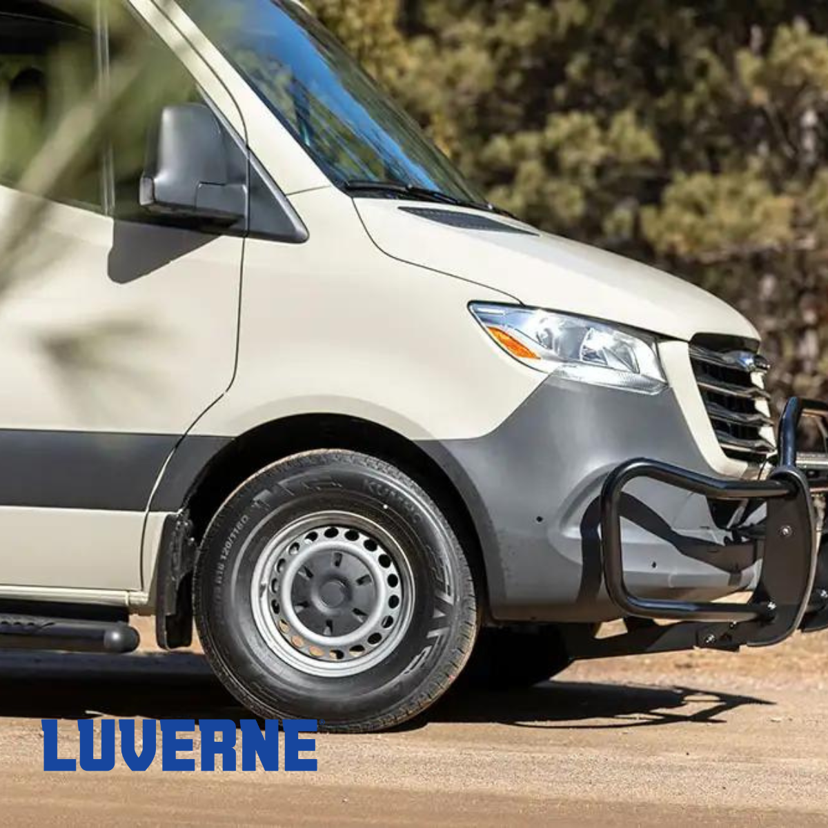 A white van is parked on a dirt road.