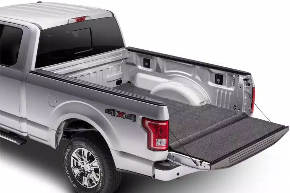 A silver pickup truck with the bed open on a white background.