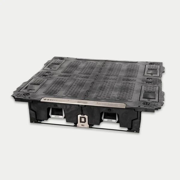 A black plastic pallet with a metal frame is sitting on a white surface.