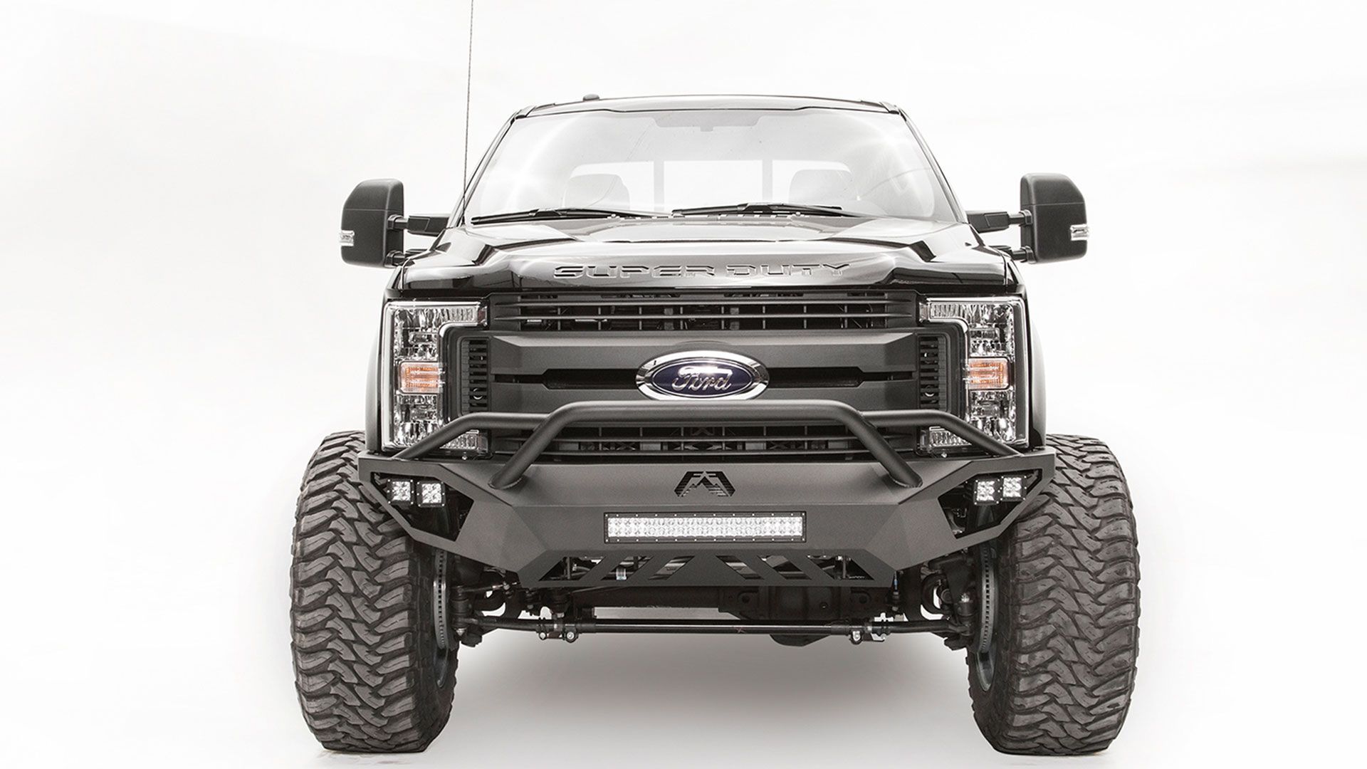 The front of a black ford truck with a bumper and tires on a white background.