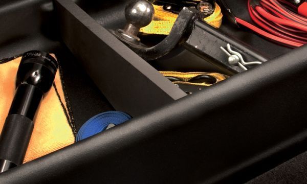 A drawer filled with tools and a flashlight