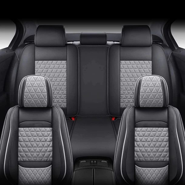 The back seat of a car with black and gray seats.