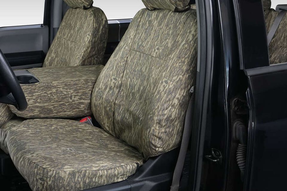 A car with a camouflage seat cover on the seats