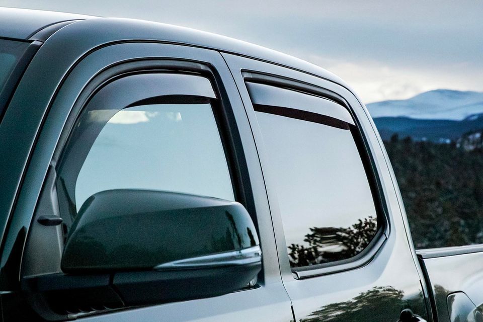 A black truck is parked in front of a mountain range