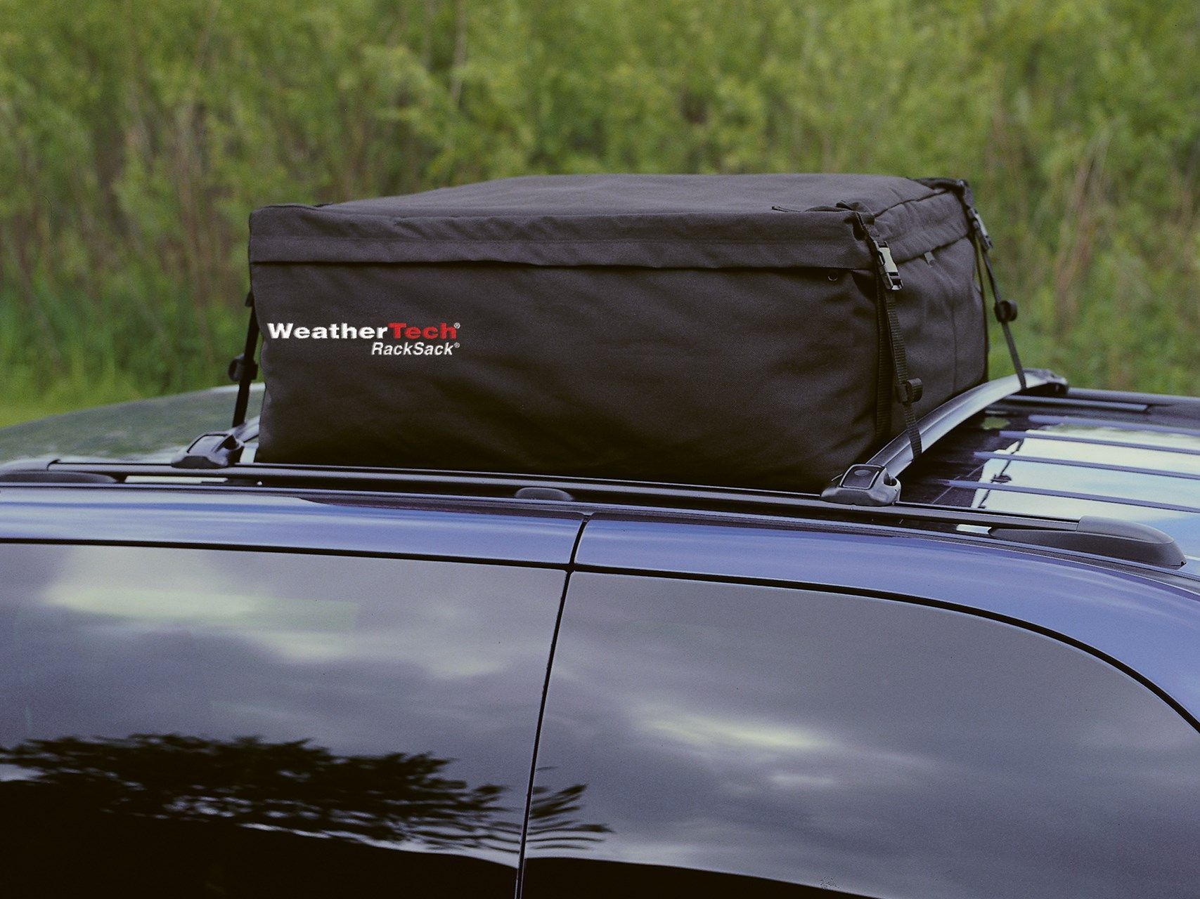 A black bag on top of a car that says weather pack