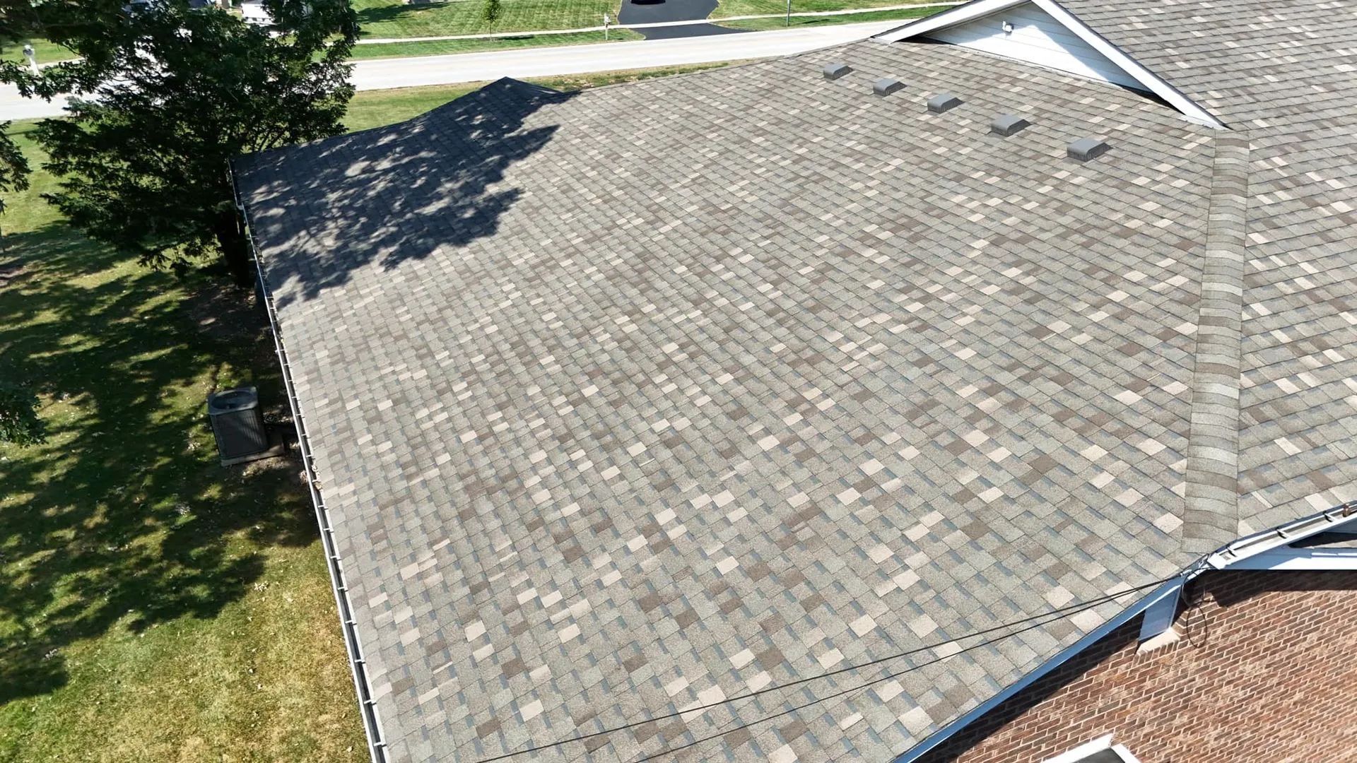 Aerial view of a house with a gray shingle roof.