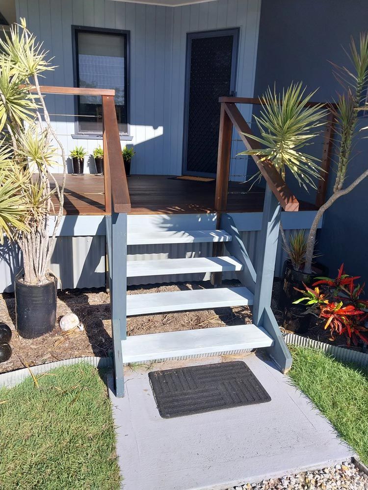 A Set Of Stairs Leading Up To A Porch Of A House After— McCarthys Property Services in Glenugie, NSW