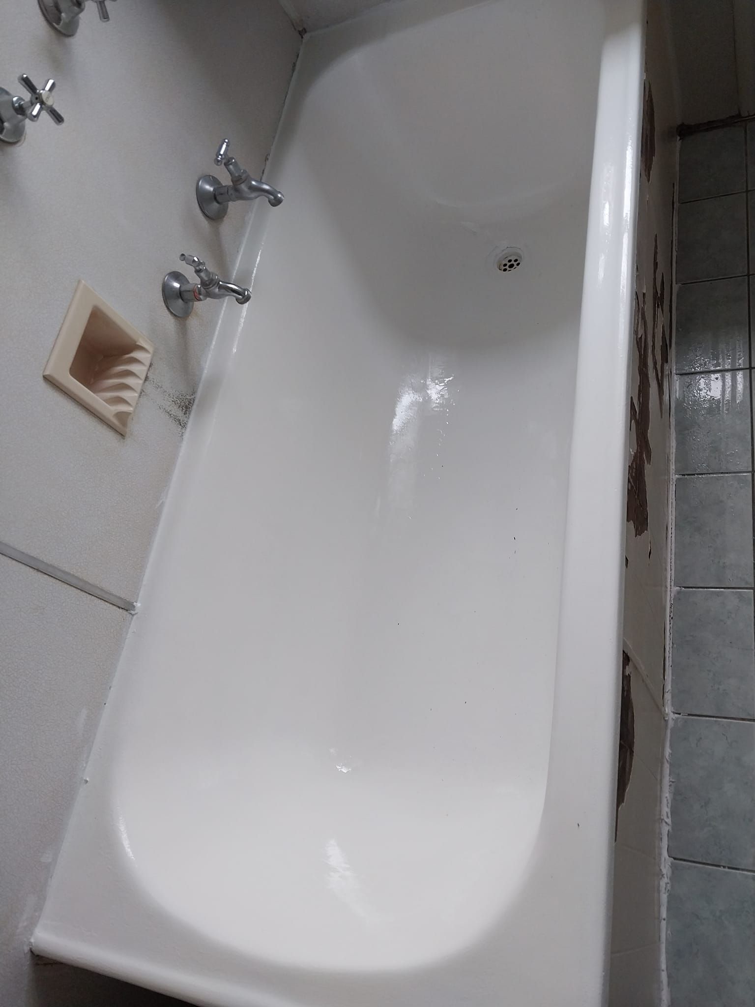 A White Bathtub Is Sitting In A Bathroom Next To A Shower After — McCarthys Property Services in Glenugie, NSW