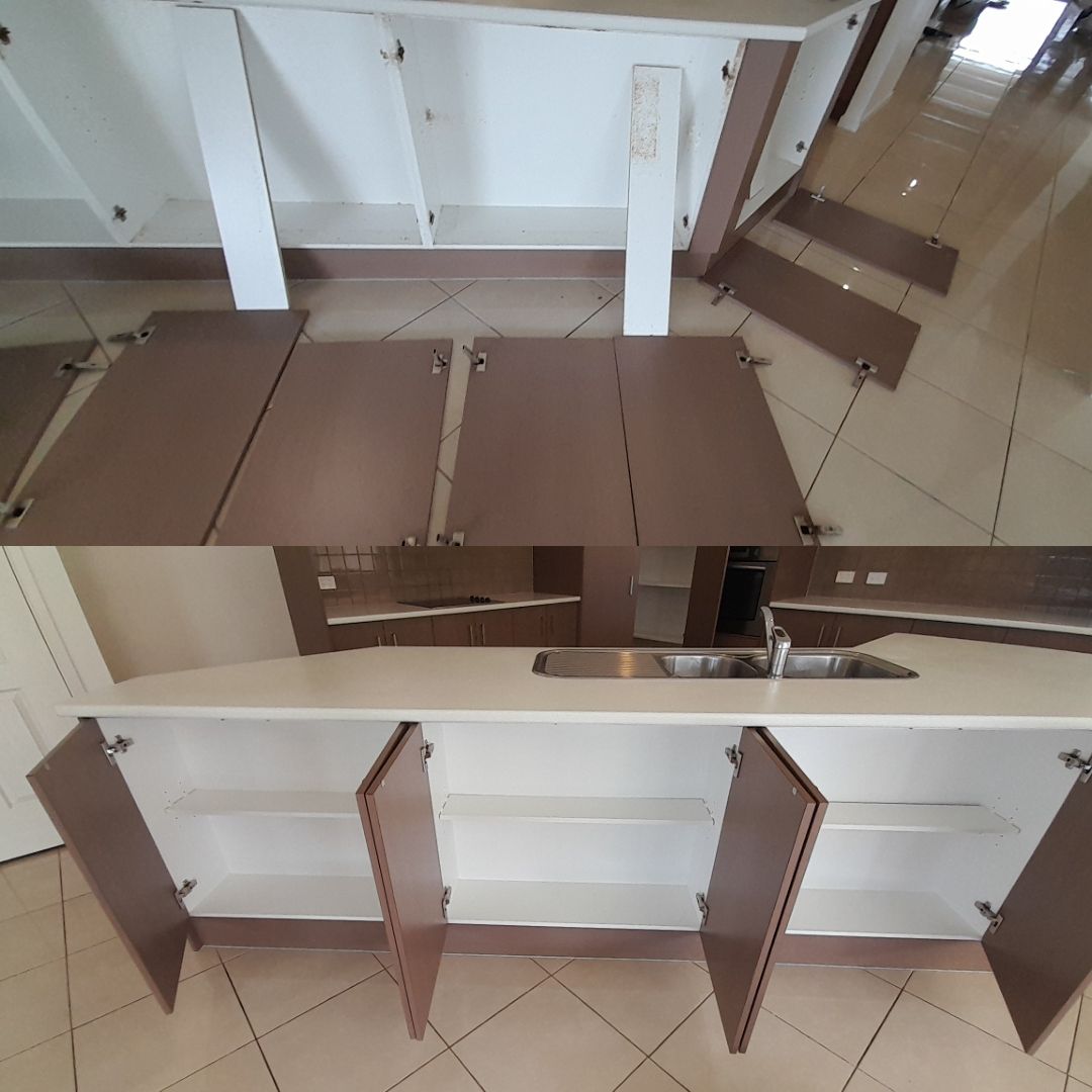 A Kitchen With A Sink And Cabinets Open — McCarthys Property Services in Glenugie, NSW