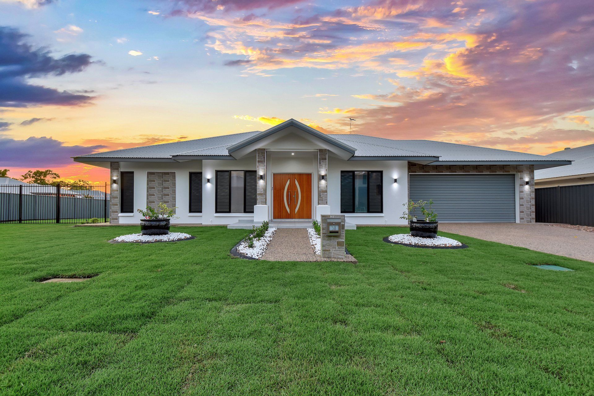 A large white house with a large lawn in front of it.