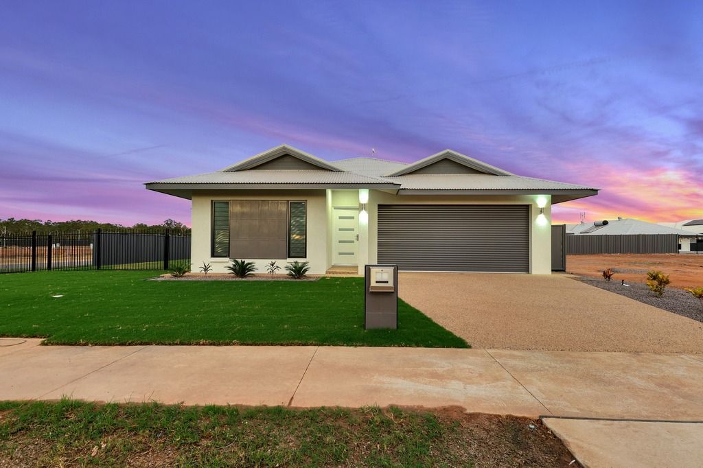 An empty living room with a ceiling fan and a stone wall.