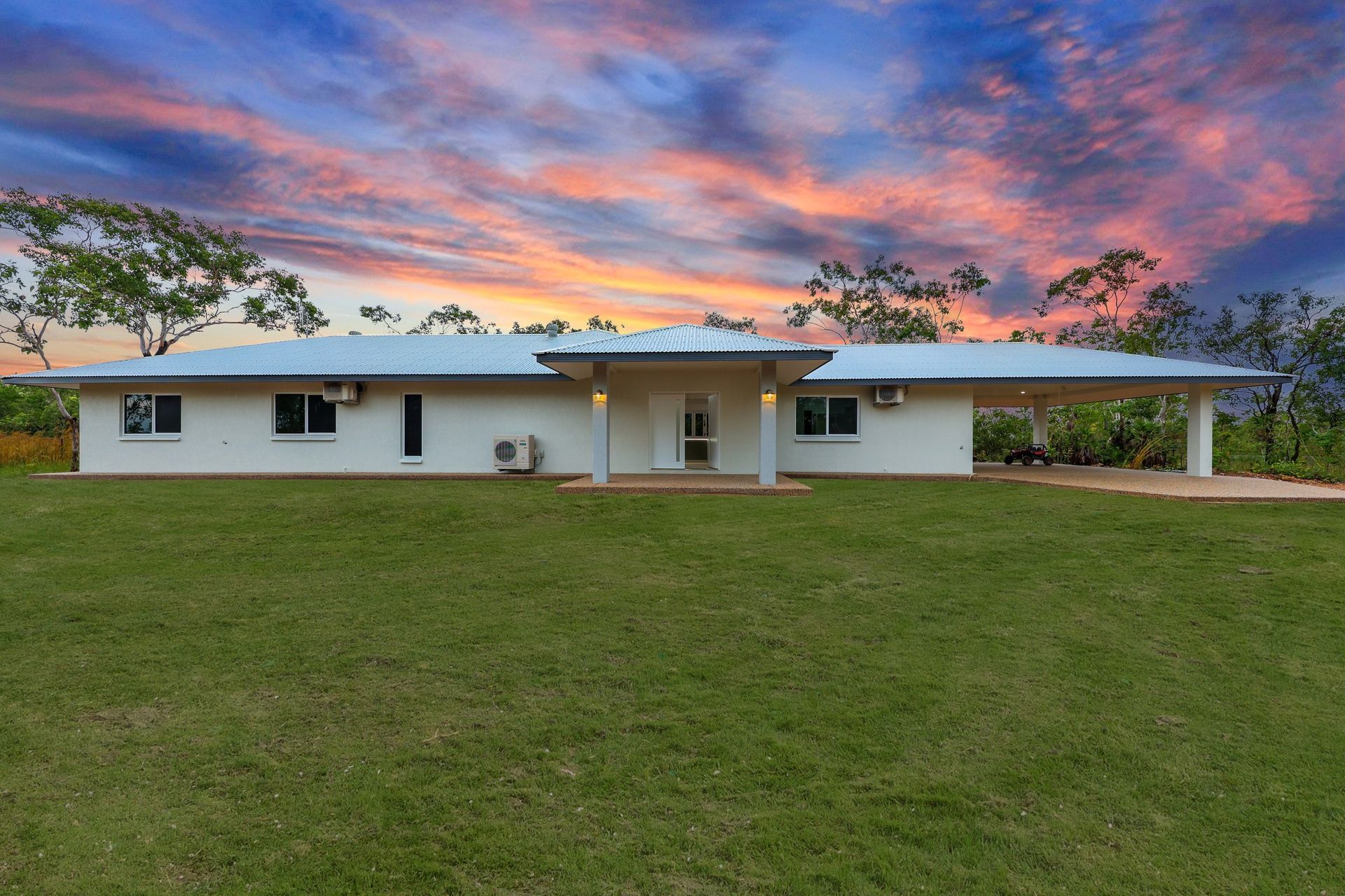 An empty living room with a ceiling fan and a stone wall.