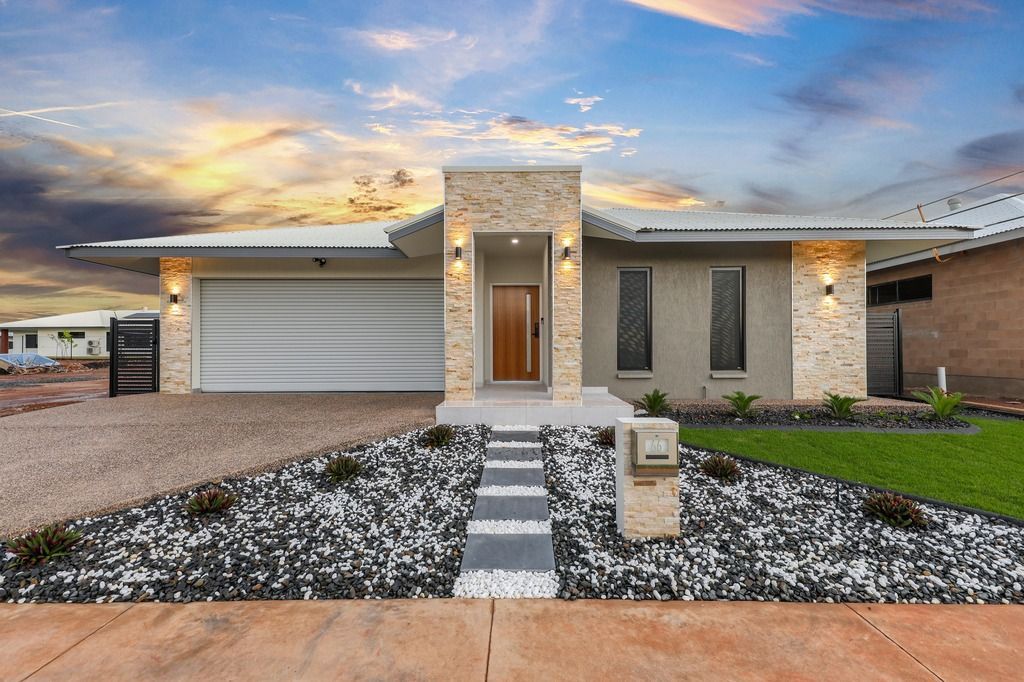 An empty living room with a ceiling fan and a stone wall.