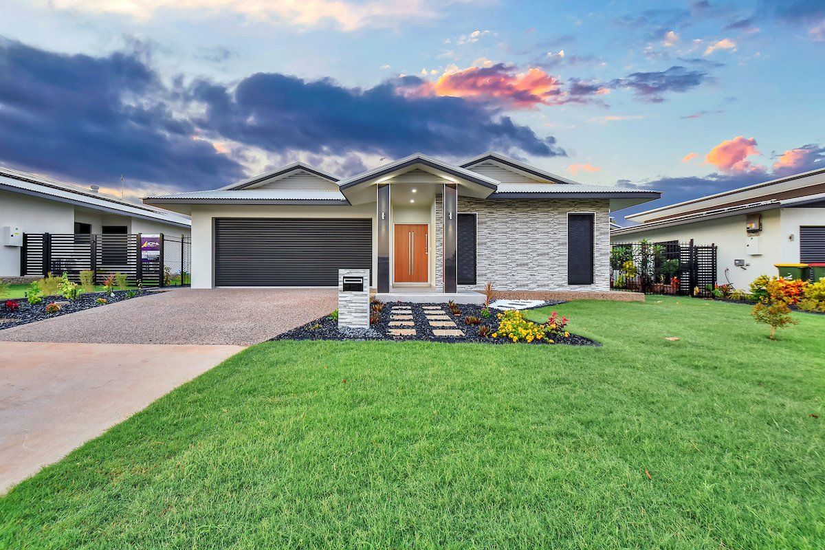 A large house with a lush green lawn in front of it.