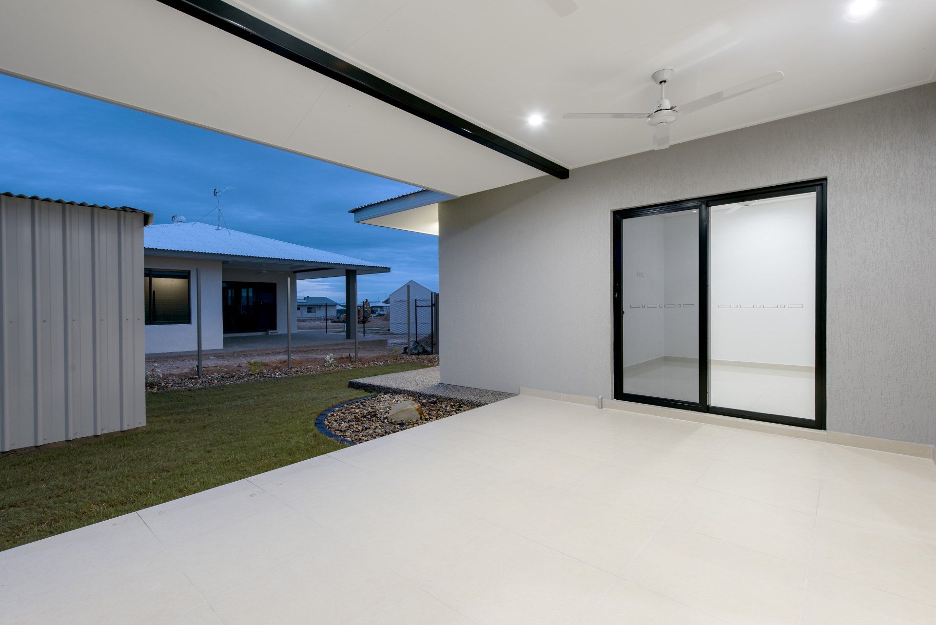 A house with a patio and sliding glass doors.