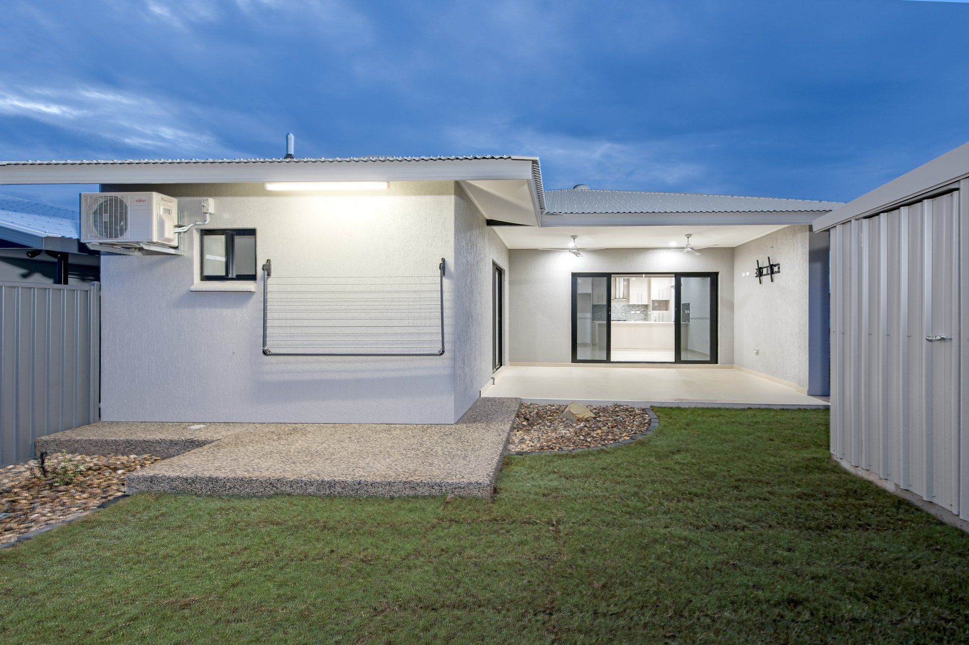 The back of a house with a lawn in front of it
