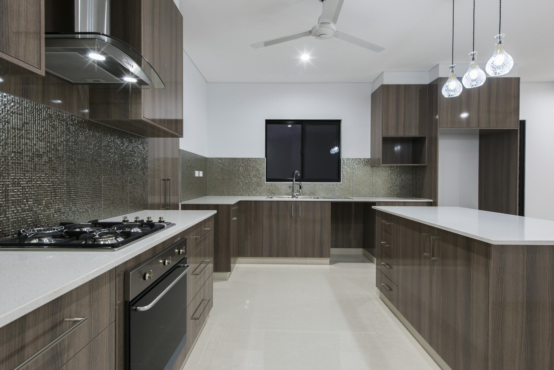 A kitchen with wooden cabinets and white counter tops