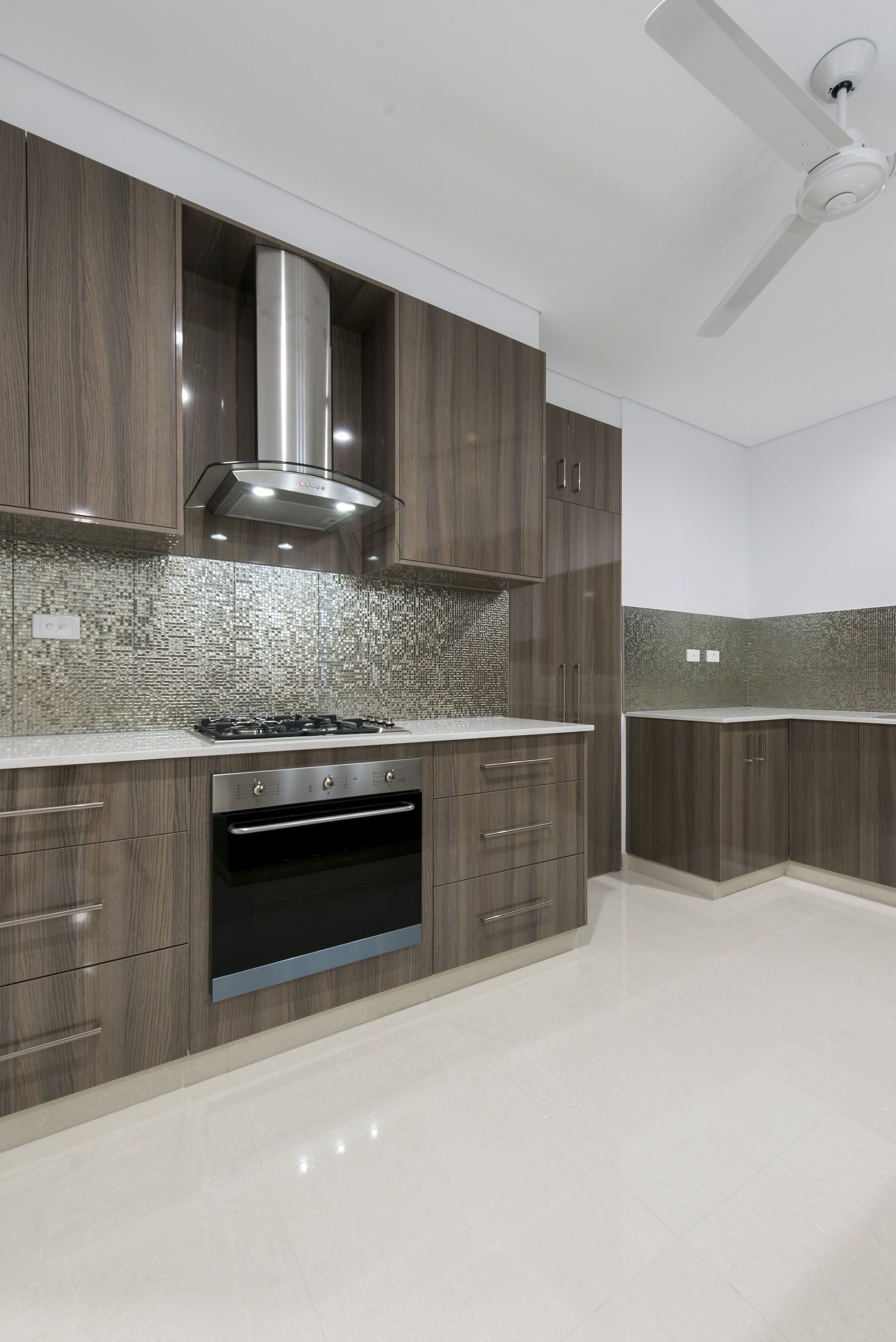 A kitchen with stainless steel appliances and wooden cabinets