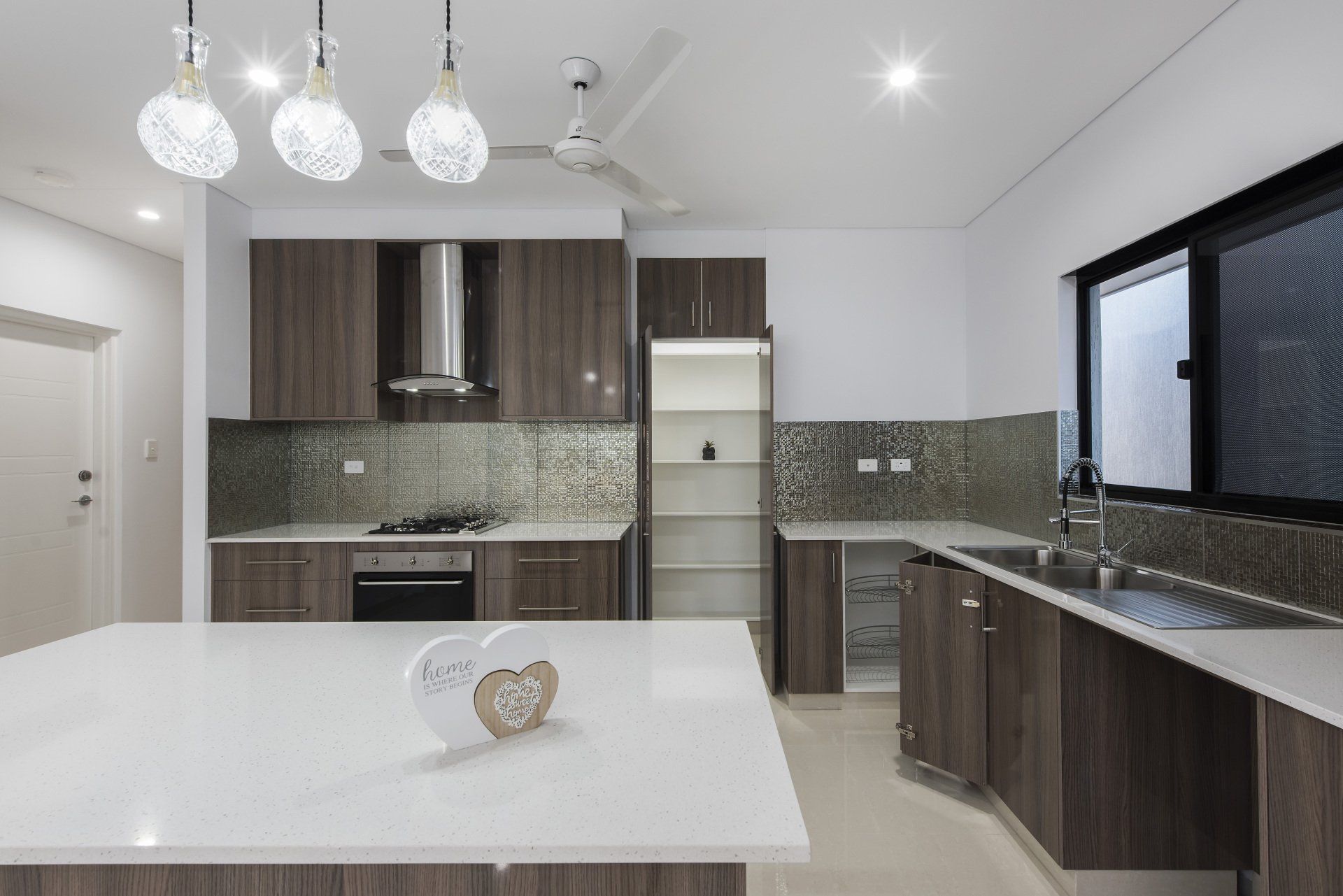 A kitchen with wooden cabinets and a white counter top.