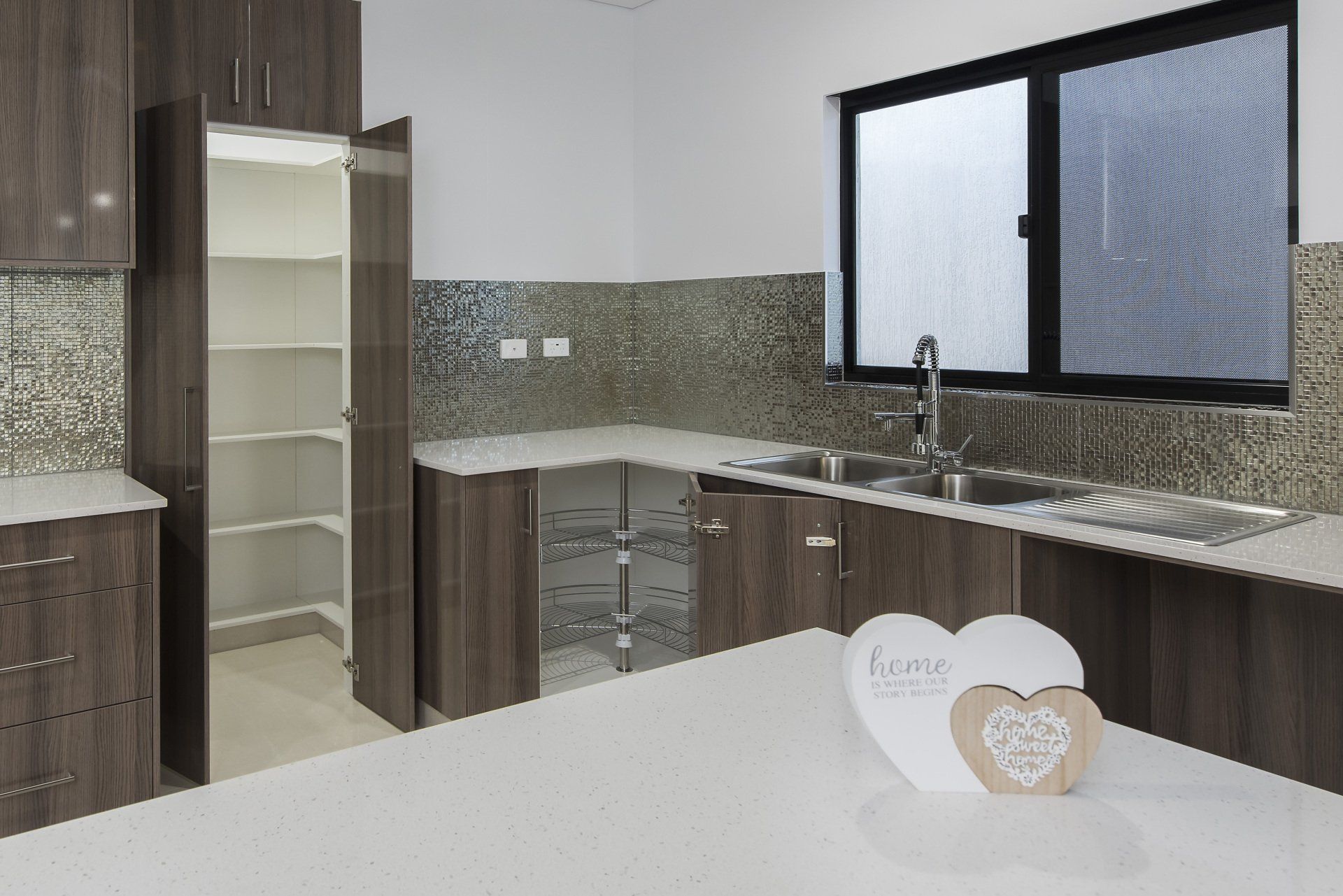 A kitchen with a heart shaped decoration on the counter.
