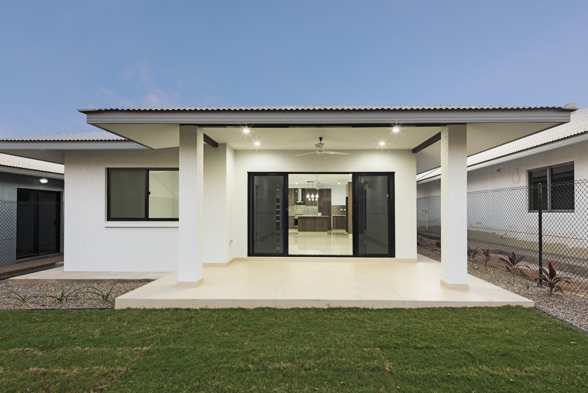 A white house with a patio in front of it.