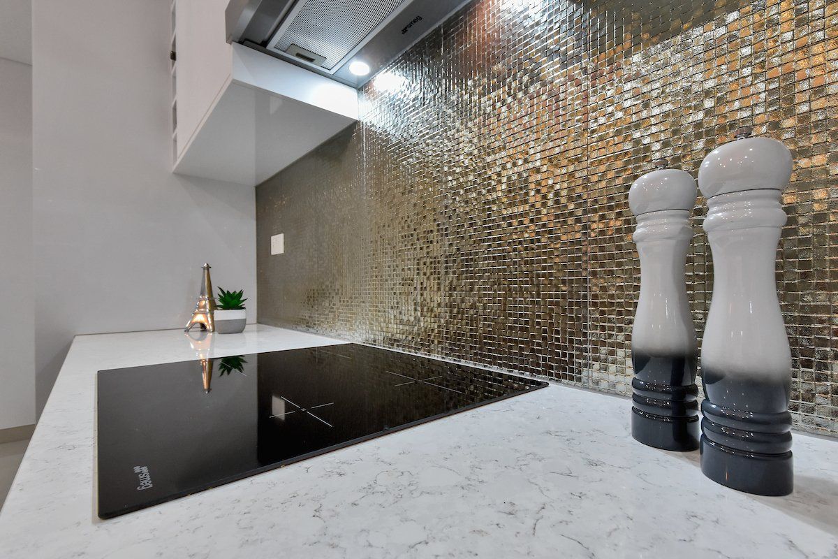 There are two salt and pepper shakers on the counter in the kitchen.