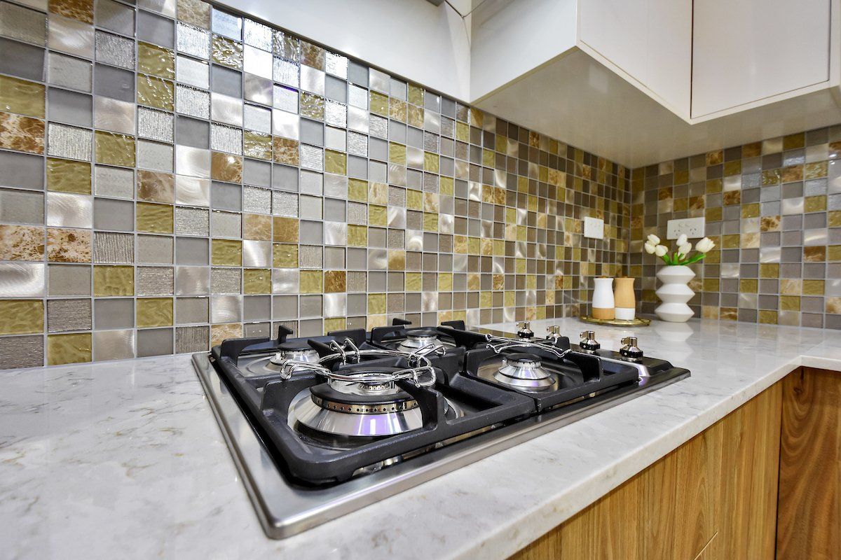 A stove top oven is sitting on top of a counter in a kitchen.