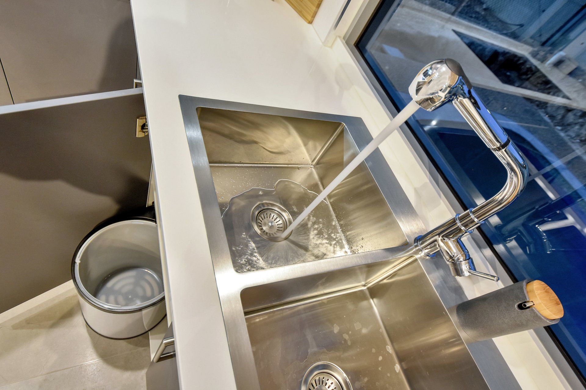 A kitchen sink with two sinks and a faucet.