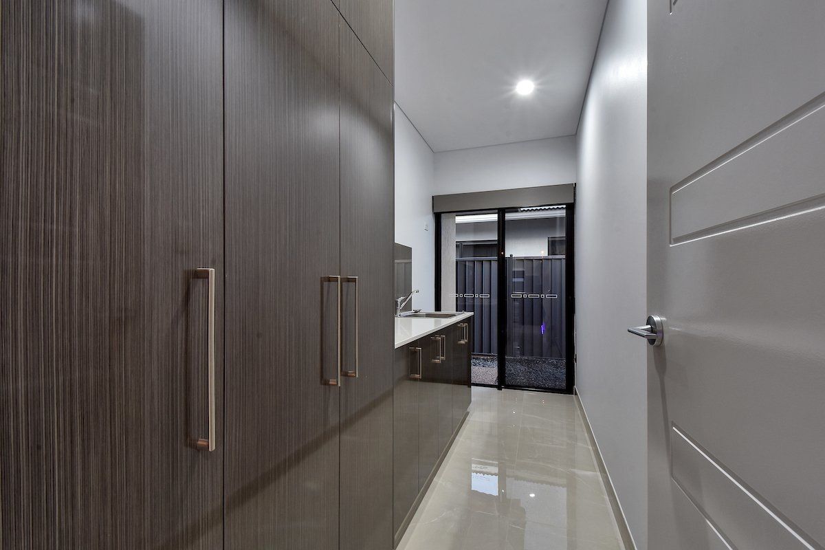 A hallway with lots of cabinets and a door