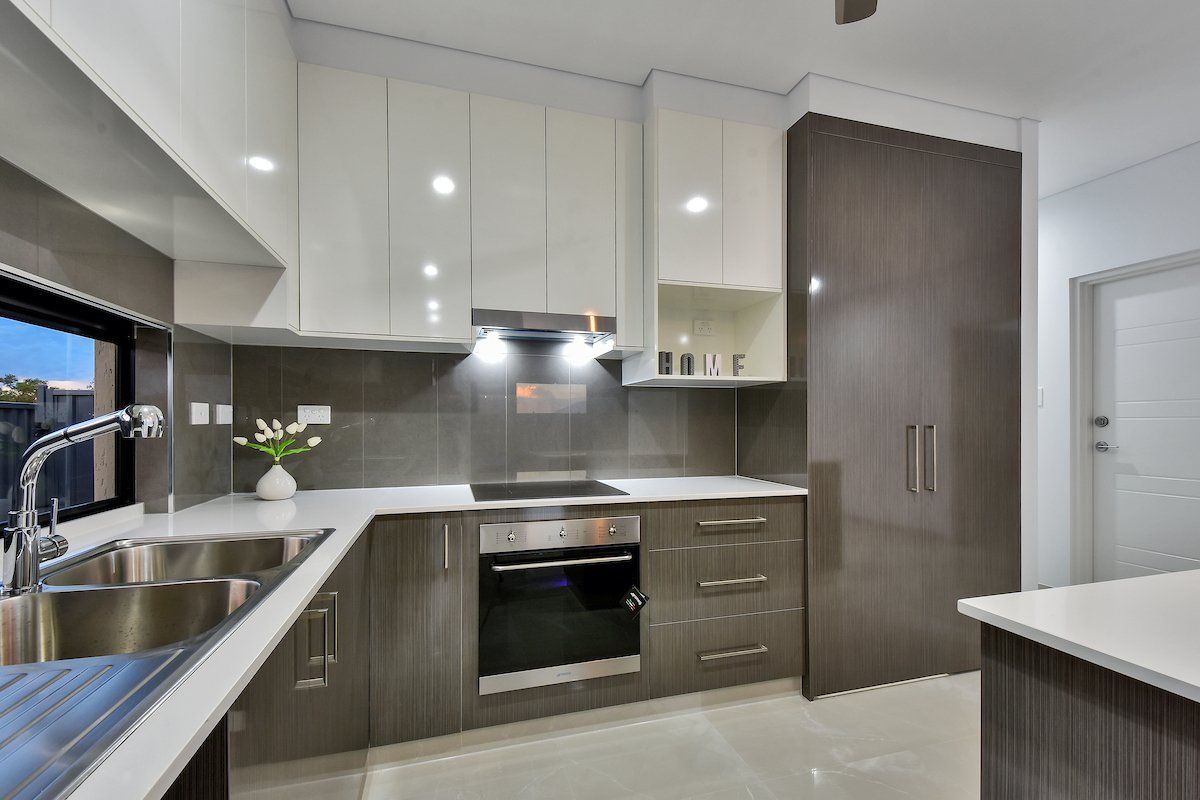 A kitchen with stainless steel appliances and a sink.