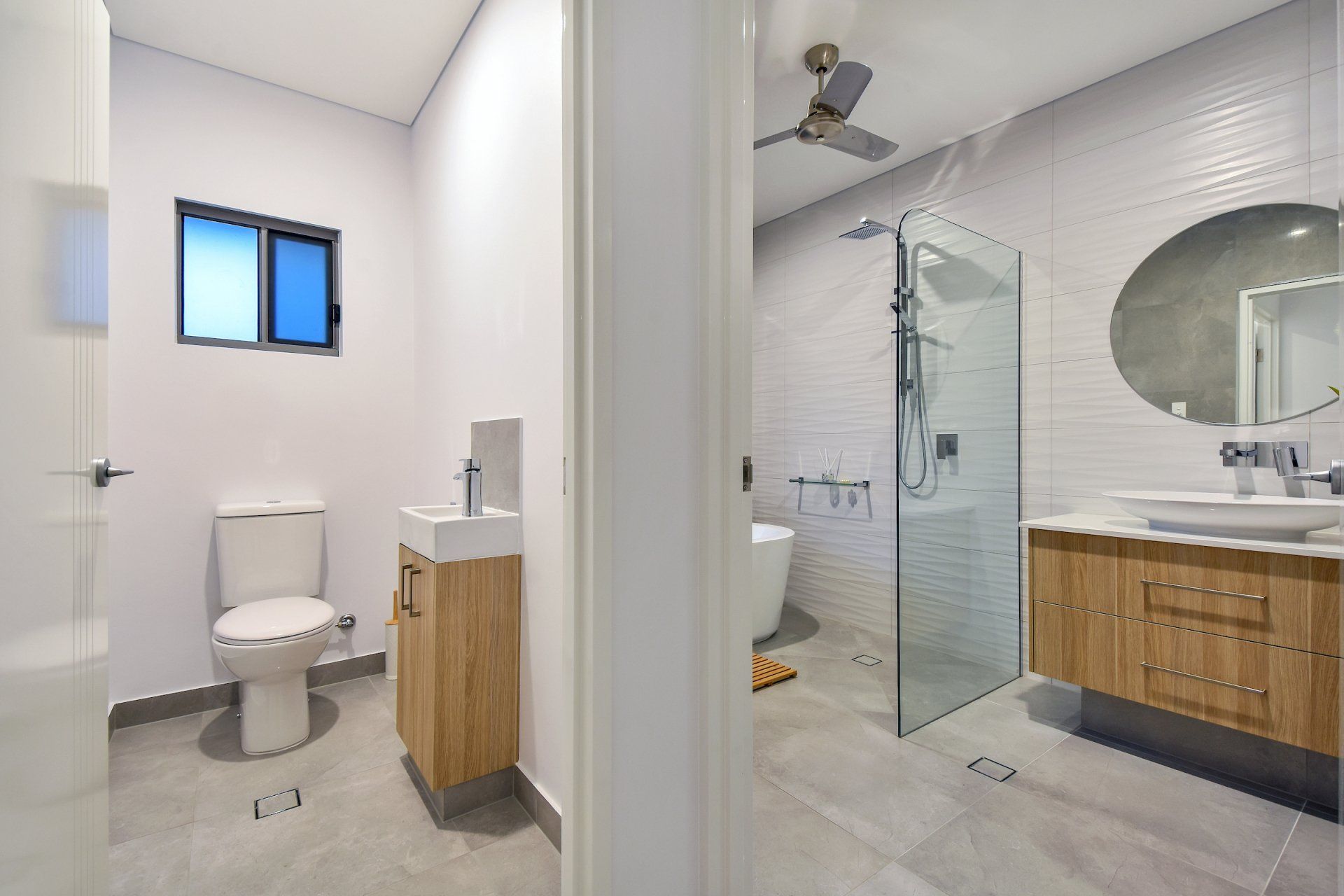 A bathroom with a toilet , sink , and walk in shower.