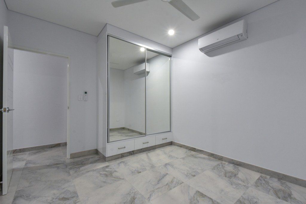 There is a ceiling fan in the room and a large mirror on the wall.