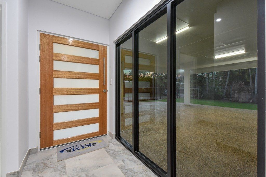 A hallway with sliding glass doors and a wooden door.