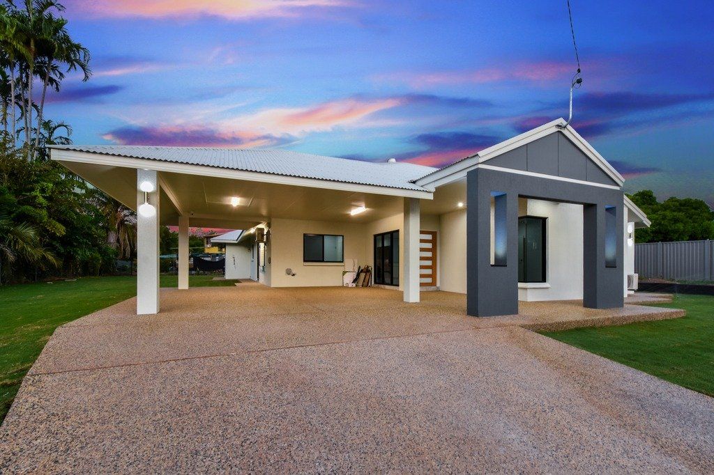 A house with a gravel driveway in front of it
