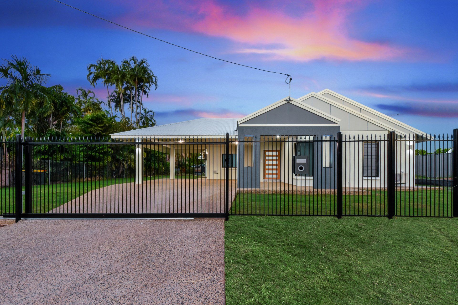 A house with a fence around it and a driveway