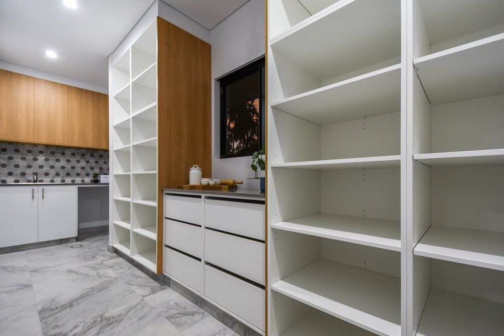 A kitchen with a lot of shelves and drawers.