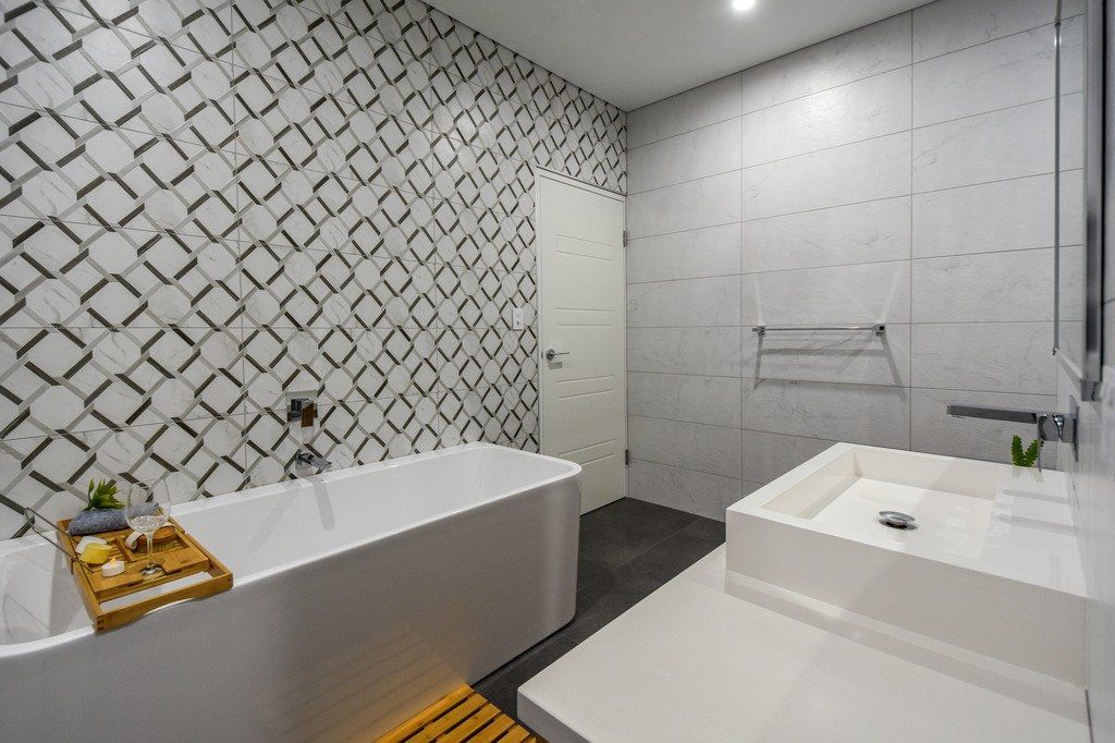 There is a bathtub and a sink in the bathroom.