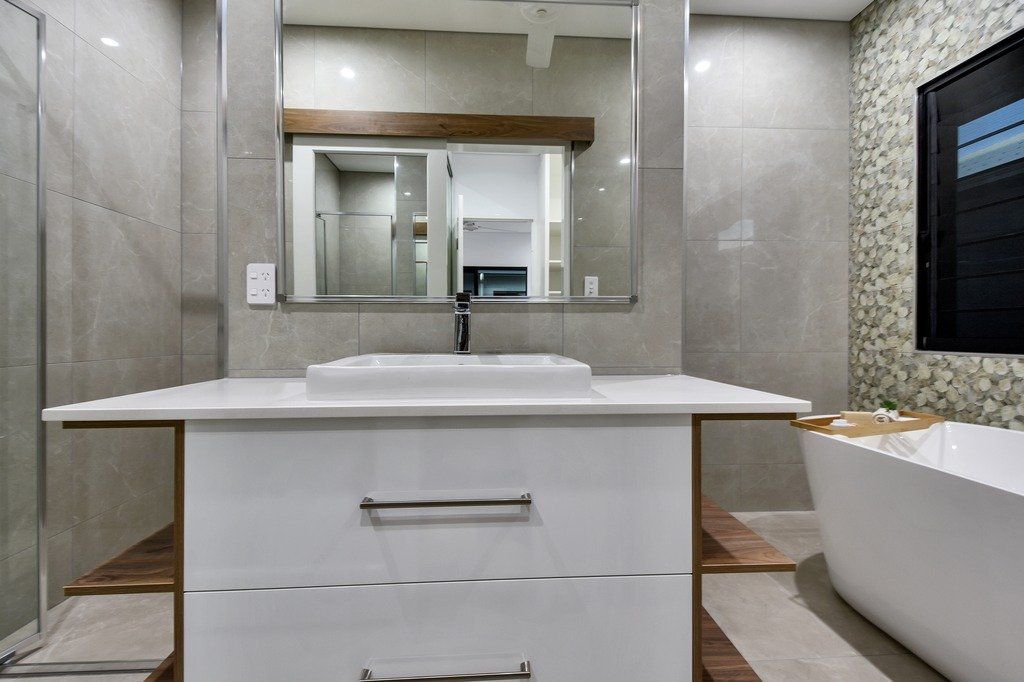 A bathroom with a sink , mirror and bathtub