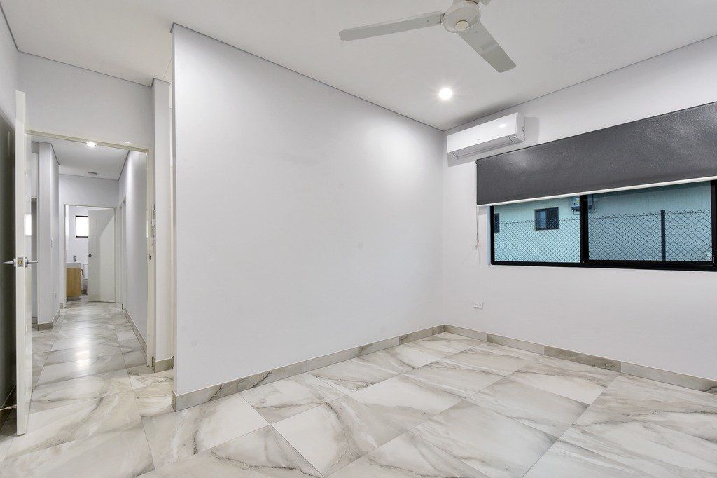 An empty room with a ceiling fan and a window