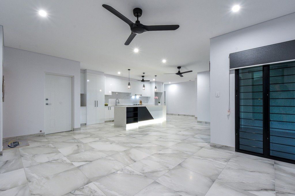 There is a ceiling fan in the middle of the room.