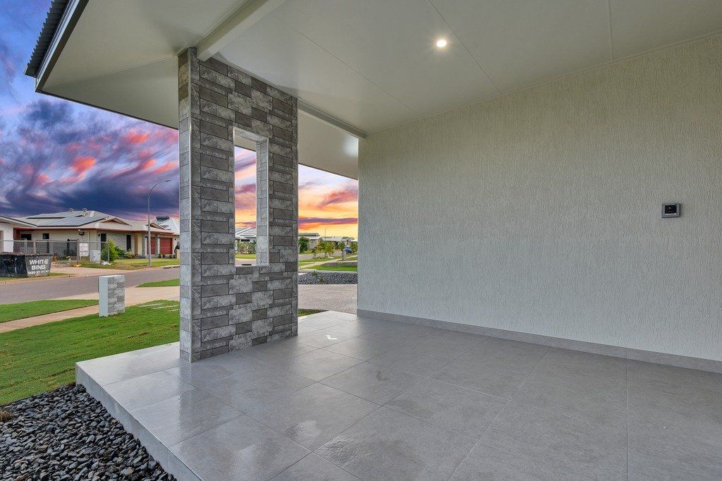 An empty garage with a stone wall and a window