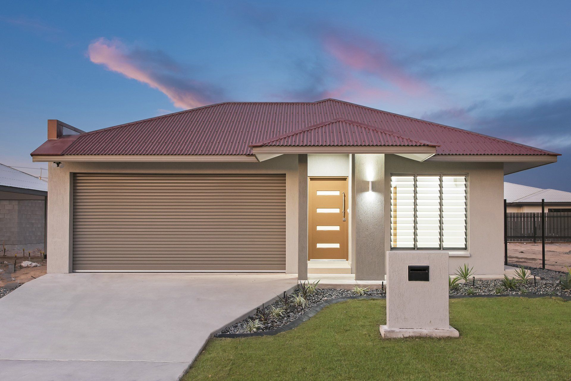 A house with a red roof and a brown garage door