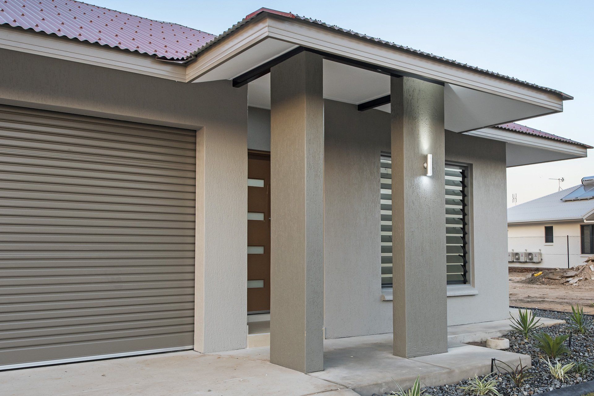 A house with a purple roof and a gray garage door