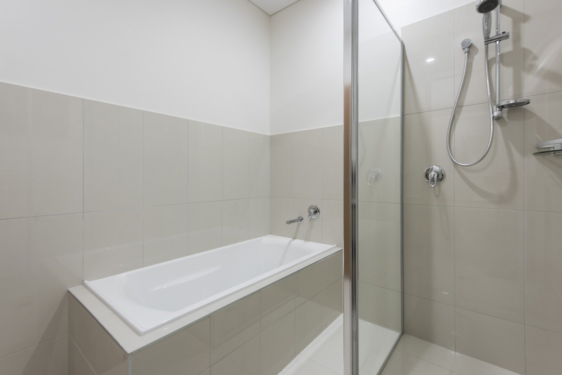 A bathroom with a bathtub and a walk in shower.