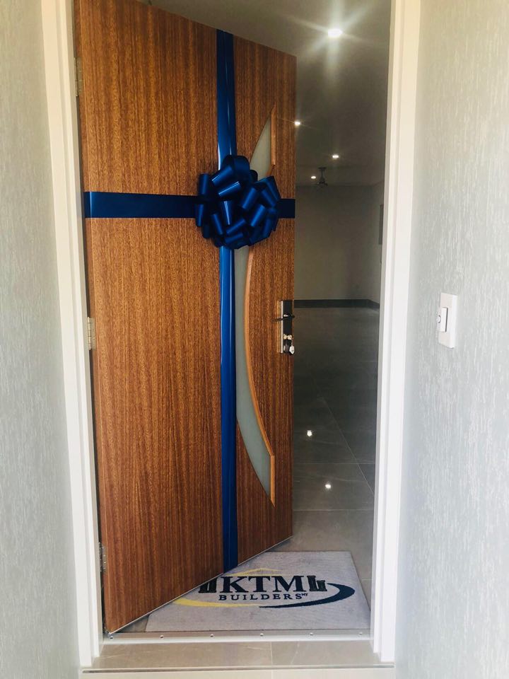 A wooden door with a blue bow on it